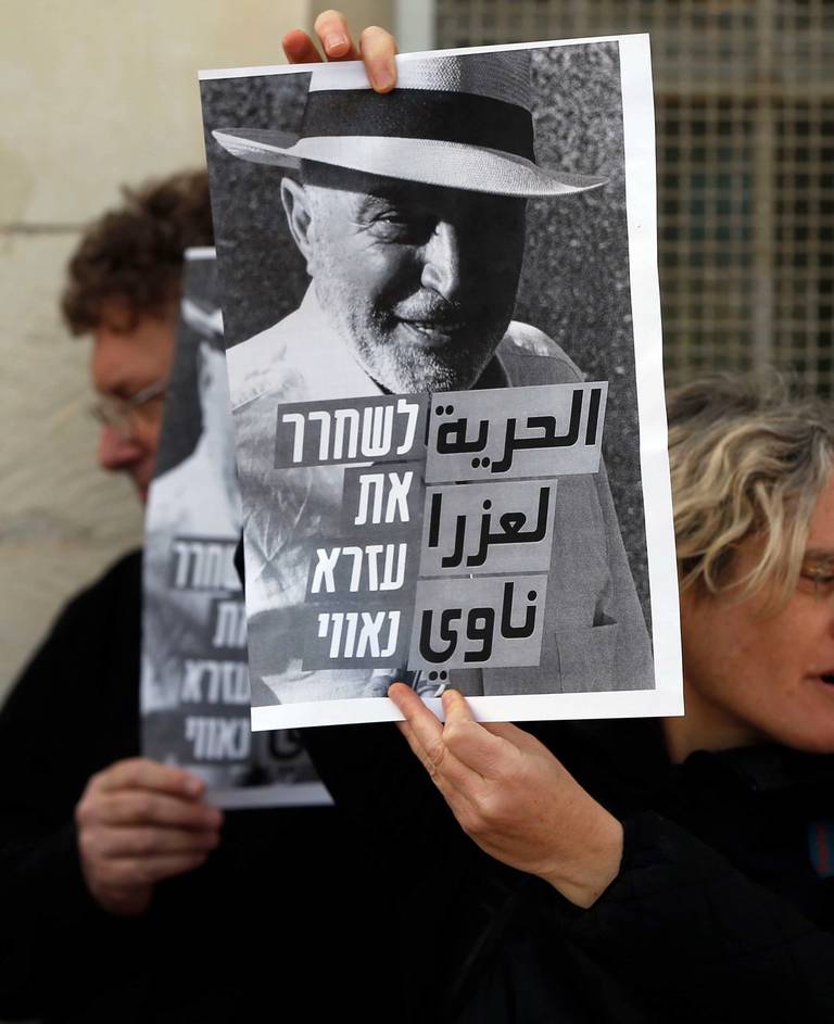 Israeli left-wing activists hold posters outside a Jerusalem courthouse during a demonstration to ask for the release of Ezra Nawi, on Jan. 18, 2016