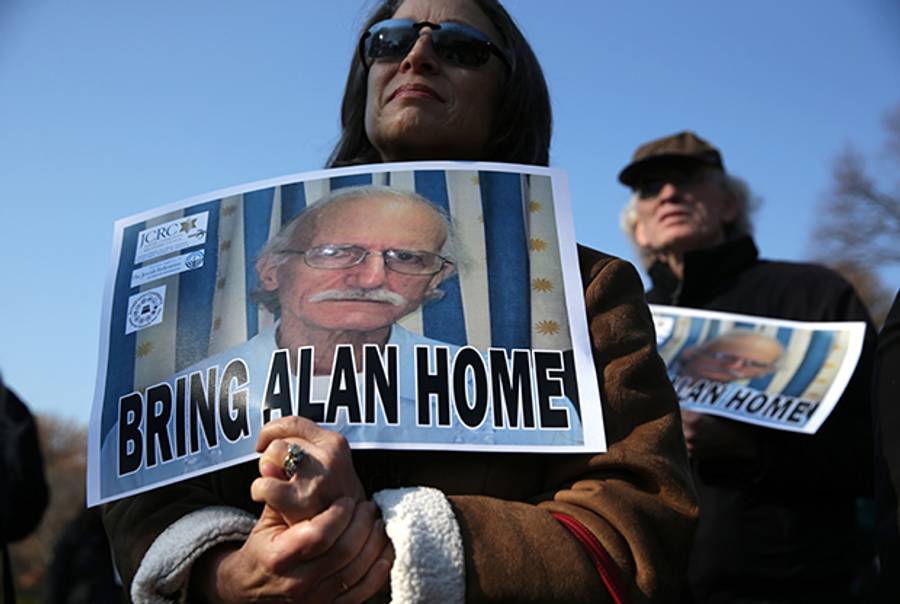Supporters outside the White House hold signs to call for U.S. citizen Alan Gross, who is currently being held in a Cuban prison, to be brought home, December 3, 2013. (Alex Wong/Getty Images)