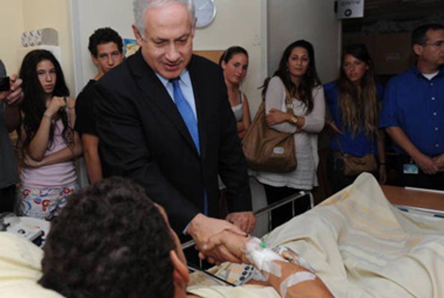 Prime Minister Netanyahu visits a wounded soldier in Tel Aviv today.(Amos Ben Gershom/GPO via Getty Images)