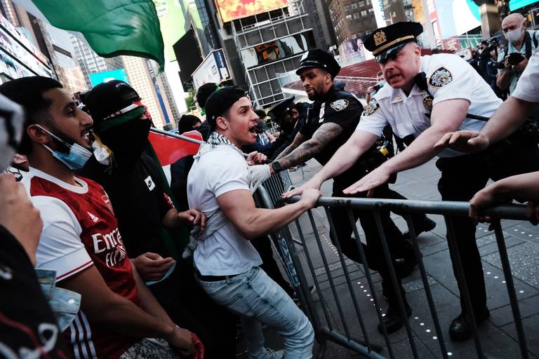 Pro-Palestinian protesters face off with a group of Israel supporters and police in a violent clash in New York’s Times Square on May 20, 2021