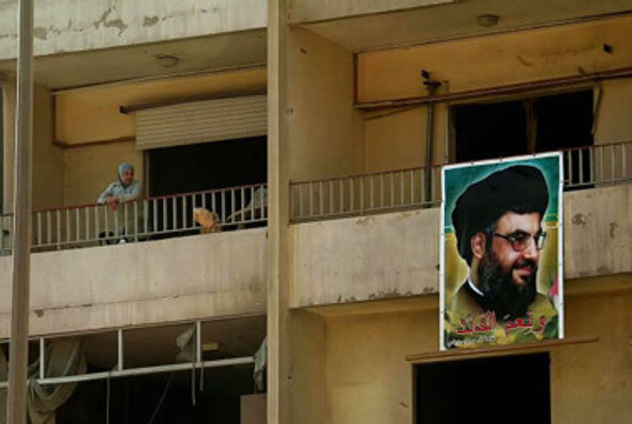 A poster of Nasrallah hangs from a damaged apartment building in a southern suburb of Beirut in September, 2006, after the end of the war with Israel.(Anwar Amro/AFP/Getty Images)
