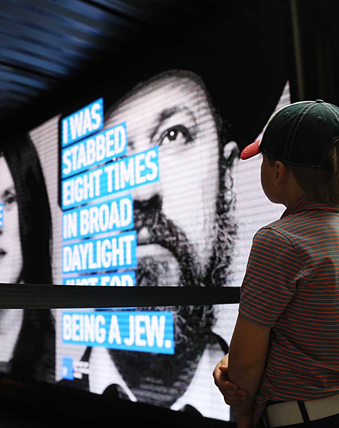 A child watches the press conference at North Station for the Face Jewish Hate campaign to raise public awareness against an alarming rise in antisemitism.