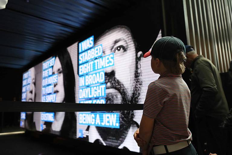 A child watches the press conference at North Station for the Face Jewish Hate campaign to raise public awareness against an alarming rise in antisemitism.