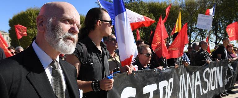 Renaud Camus stands next to members of far-right movement La Ligue du Midi on Oct. 8, 2016, in Montpellier, France, during a protest against the country's migrant and refugee policy