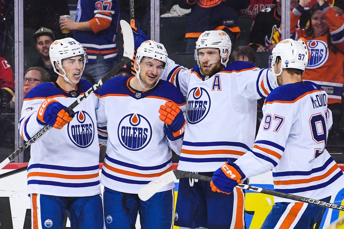 From left: Ryan Nugent-Hopkins, Zach Hyman, Leon Draisaitl, and Connor McDavid of the Edmonton Oilers celebrate after Hyman scored against the Calgary Flames during the second period of an NHL game at Scotiabank Saddledome in Calgary, Alberta, on Oct. 29, 2022