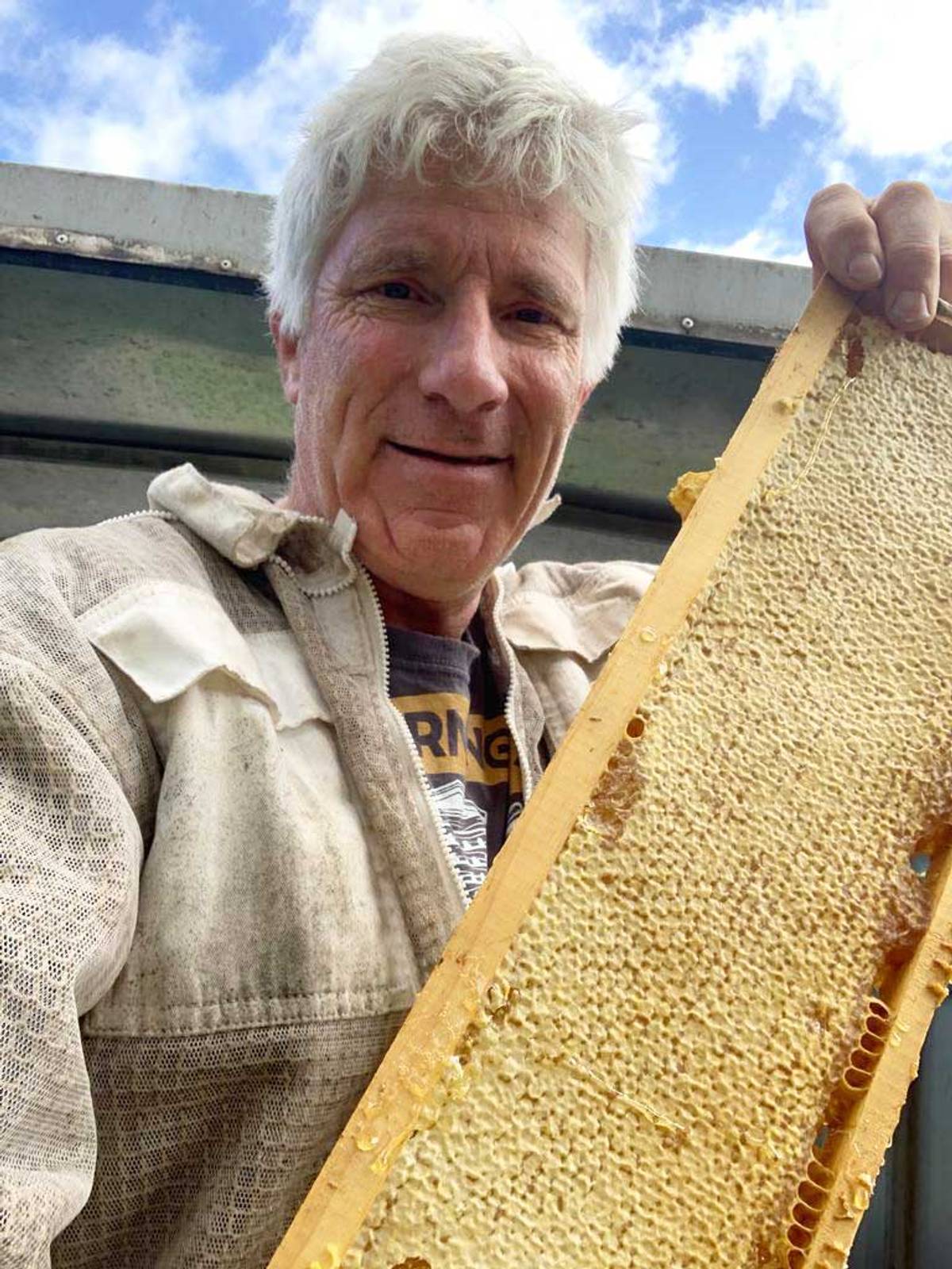 Jonathan Landes harvesting honey. On average, each hive produces around 22 pounds of honey per season.