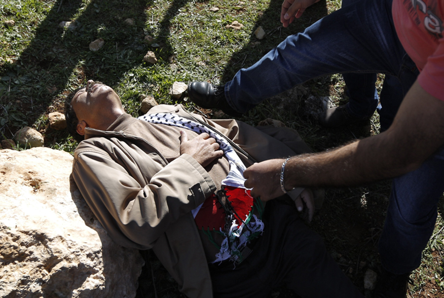 Ziad Abu Ein lies on the ground after a scuffle with Israeli forces during a demonstration in the village of Turmus Aya near Ramallah, on December 10, 2014.(Abbas Momani/AFP/Getty Images)