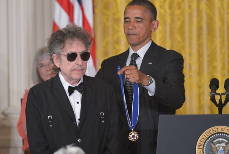 President Barack Obama presents the Presidential Medal of Freedom to musician Bob Dylan during a ceremony on May 29, 2012, in the East Room of the White House.
