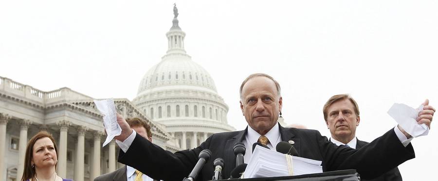 Rep. Steve King (R-IA) tears a page from the national health care bill during a press conference at the U.S. Capitol, March 21, 2012, in Washington, D.C.