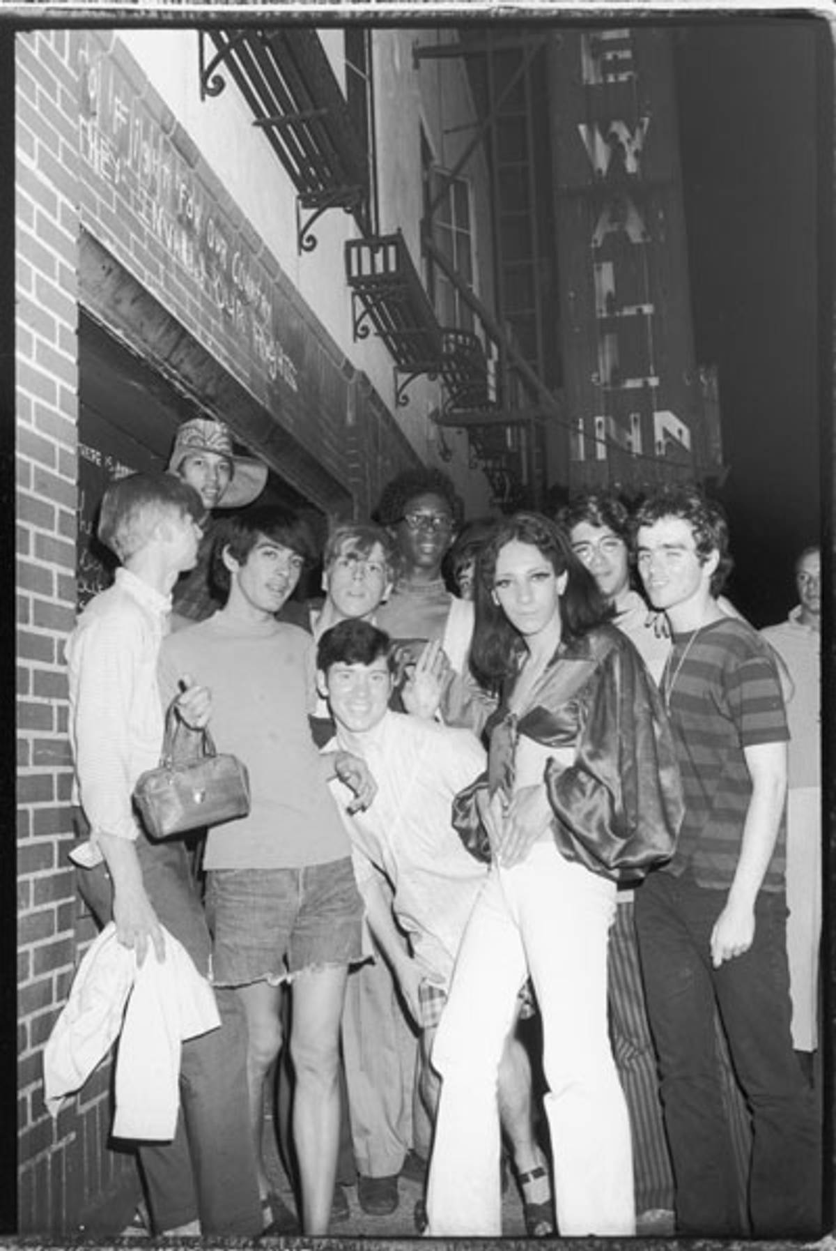 An unidentified group of young people celebrate outside the boarded-up Stonewall Inn after riots over the weekend of June 27, 1969 (Photo: Fred W. McDarrah/Getty Images)