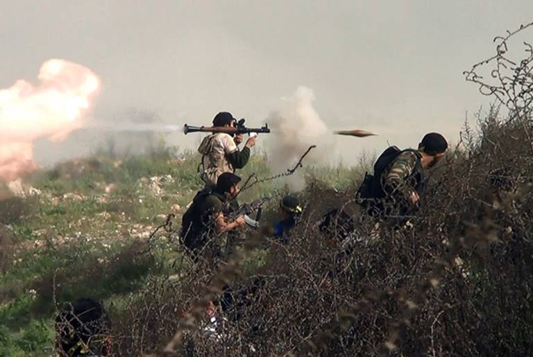 An image grab taken from a video shows an opposition fighter firing an rocket propelled grenade (RPG) on August 26, 2013 during clashes with regime forces over the strategic area of Khanasser, situated on the only road linking Aleppo to central Syria.(SALAH AL-ASHKAR/AFP/Getty Images)