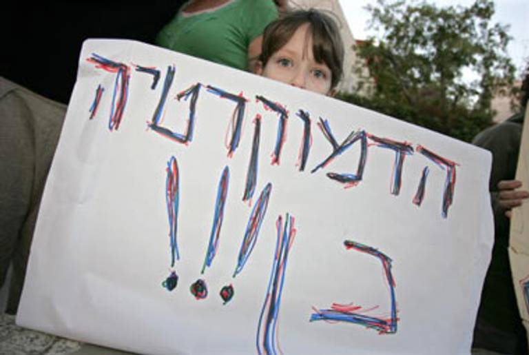 An girl holds a sign reading “Democracy Yes” during a rally ouside Sternhell’s Jerusalem home in October, 2008, after the historian was wounded in a pipe-bomb attack.(Jonathan Nackstrand/AFP/Getty Images)
