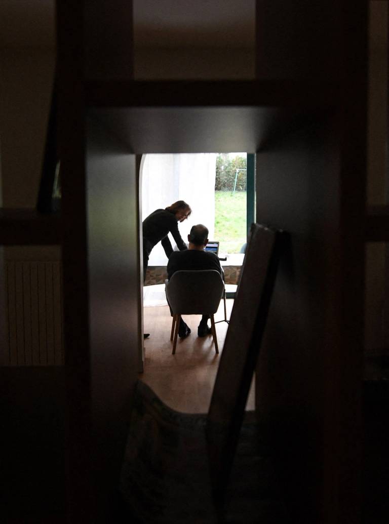 A caregiver speaks with an elderly resident—one of three Alzheimer’s sufferers in the establishment—in a house at L’Hay-les-Roses on the outskirts of Paris that is run as an alternative to the traditional home-care model