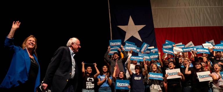 Supporters react as Democratic presidential hopeful Vermont Senator Bernie Sanders (2nd L) arrives onstage with his wife Jane O'Meara Sanders for a rally at the Abraham Chavez Theater on February 22, 2020 in El Paso, Texas.