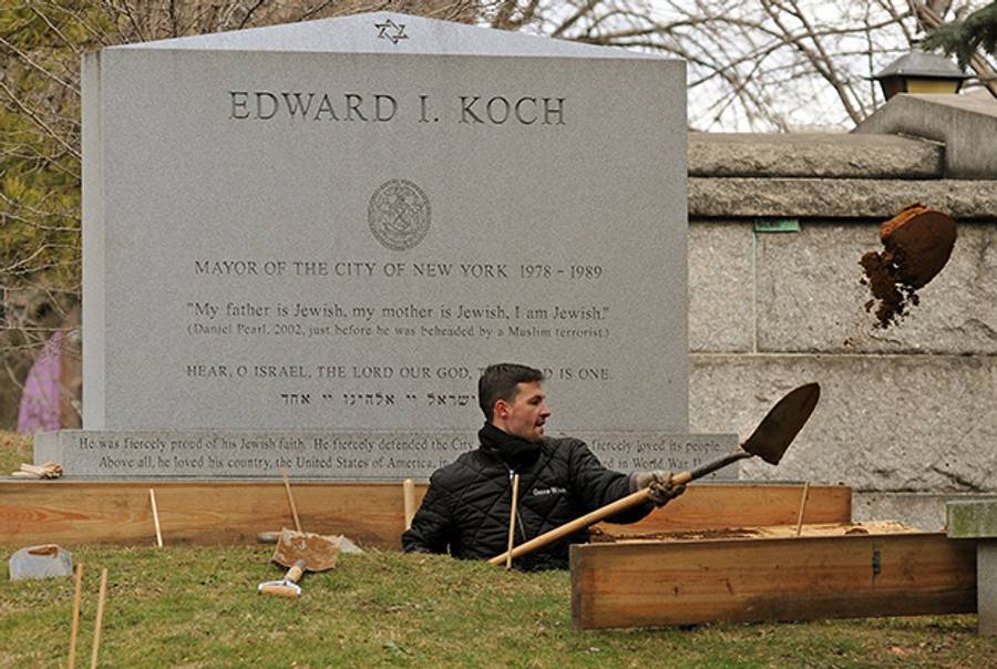 Trinity Church workers dig the grave beneath the headstone on the grave of Edward I. Koch, former mayor of the City of New York, on Friday, Feb. 1, 2013. 